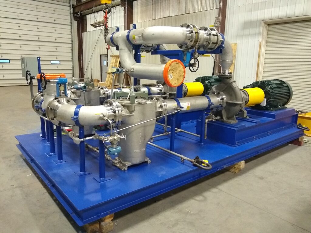 Industrial GPM pump skid system inside a warehouse.